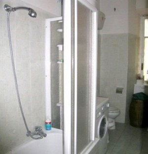 This private bathroom is used by clients for the King size bed room. Has a  tub/shower, washing machine, hairdryer and towels dryer.